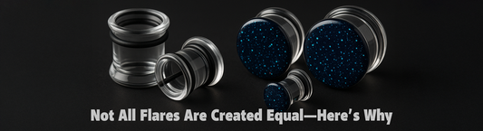 clear glass single flare tunnels with black rubber o rings and black glass double flare plugs with crushed opals on a dark grey ground